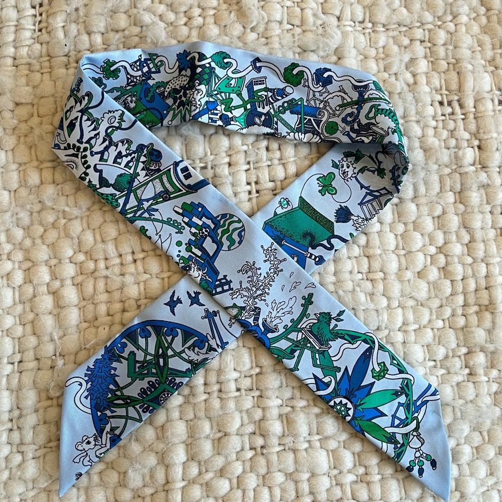 Hermés twilly scarf in “La Folle Parade” print blue & green